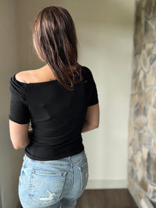 black asymmetrical twist ribbed top